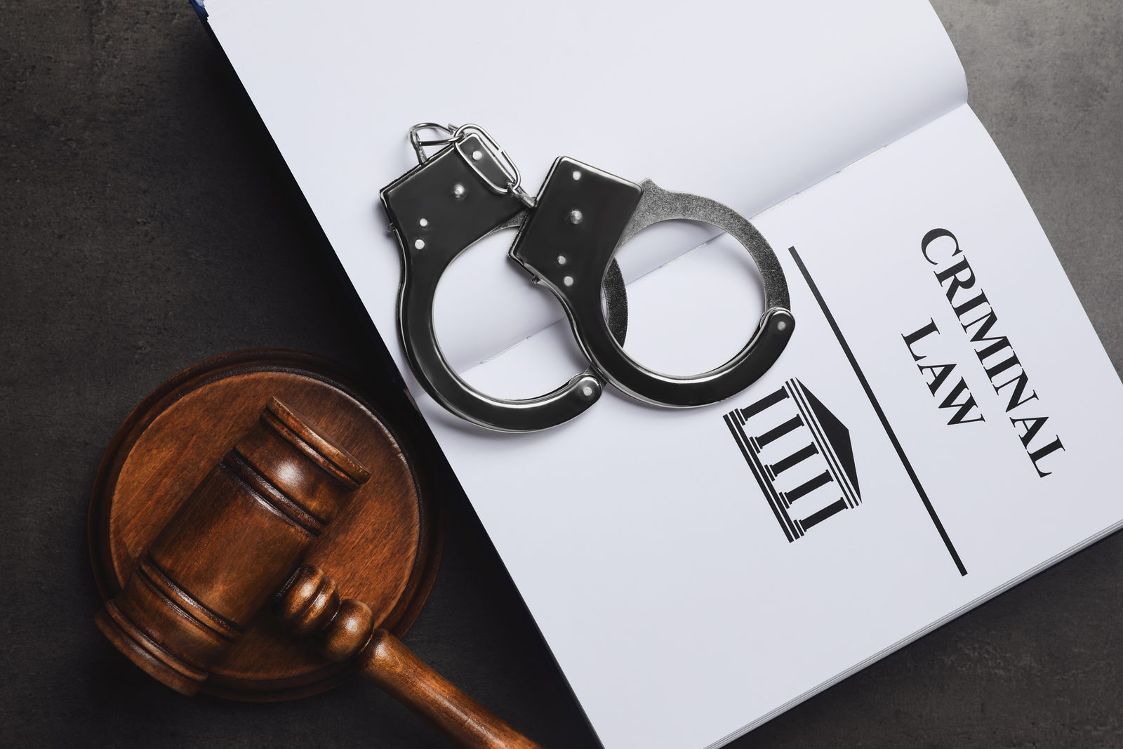 New Jersey criminal law book with gavel and handcuffs