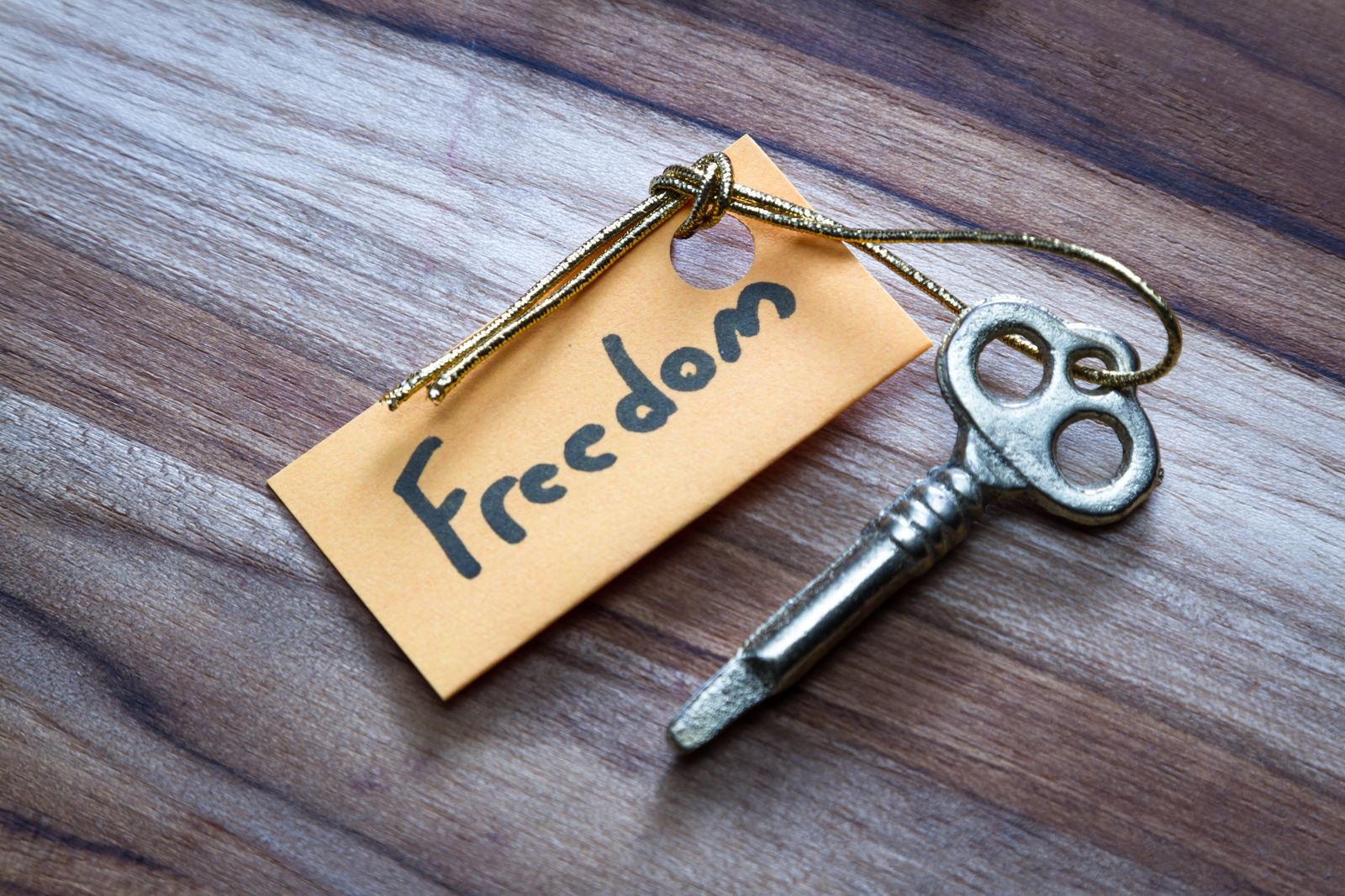 A key with a paper tag reading “Freedom”