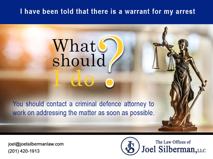 I have been told that there is a warrant for my arrest. What should I do?