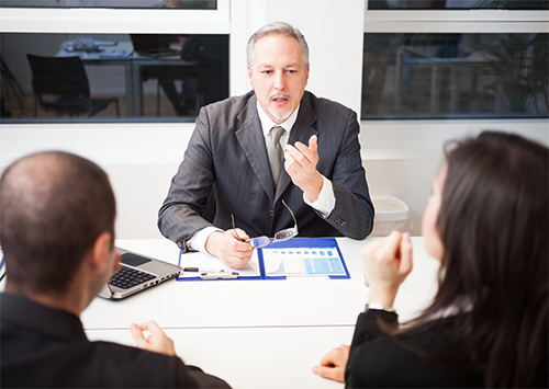 Attorney talking a couple in office